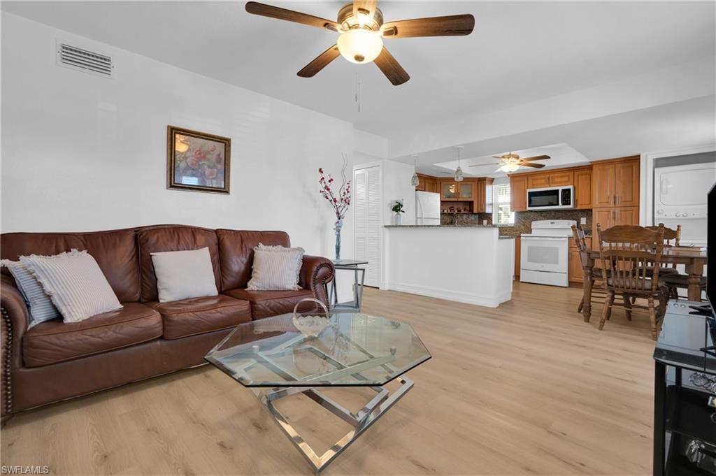 Image 3: Living area featuring light wood-style floors and a ceiling fan