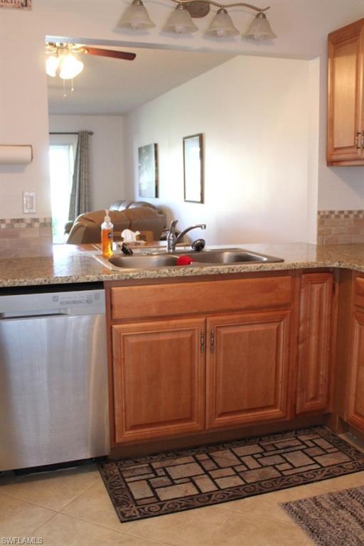 Image 3: Kitchen featuring open floor plan, a peninsula, dishwasher, ceiling fan, and light tile patterned floors