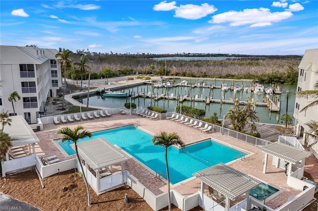 Image 2: View of pool featuring a water view and a pergola