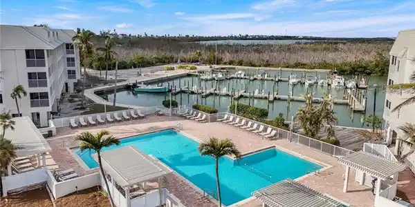 Image 2: View of pool featuring a water view and a pergola