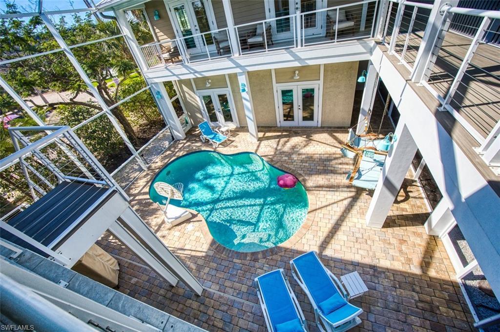 Image 2: Swimming pool featuring french doors, a patio, and a balcony