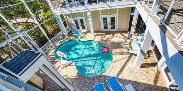 Image 2: Swimming pool featuring french doors, a patio, and a balcony