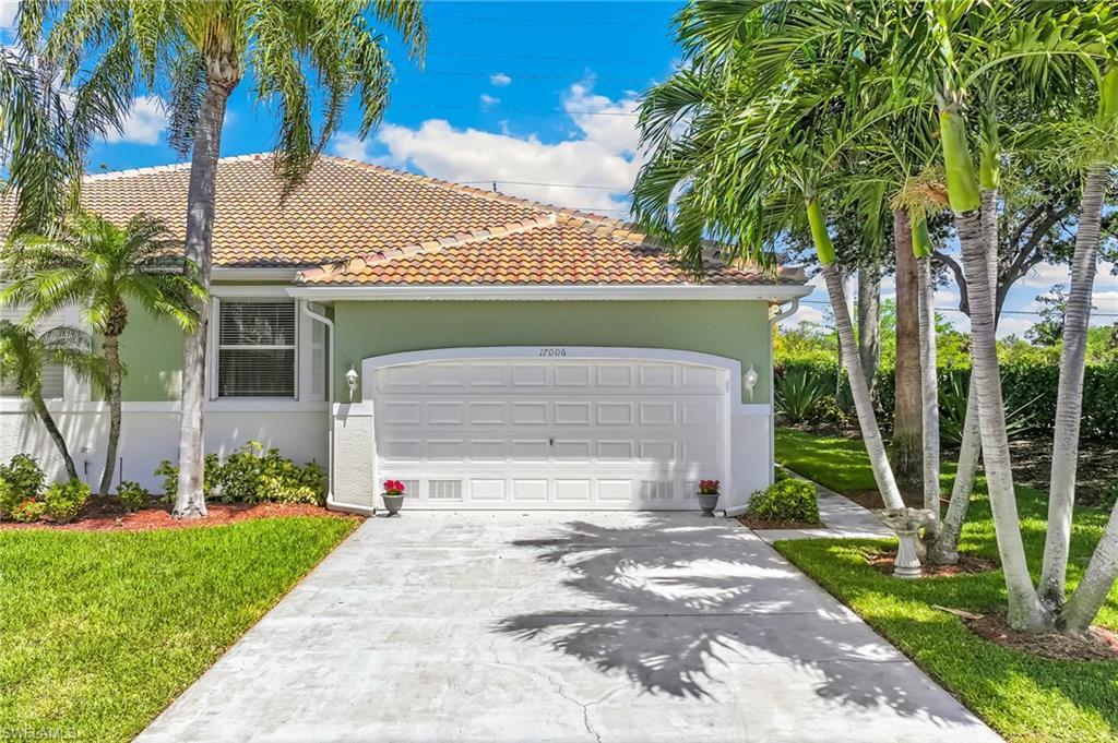 Image 3: East side of attached villa with lovely landscaping and privacy berm.