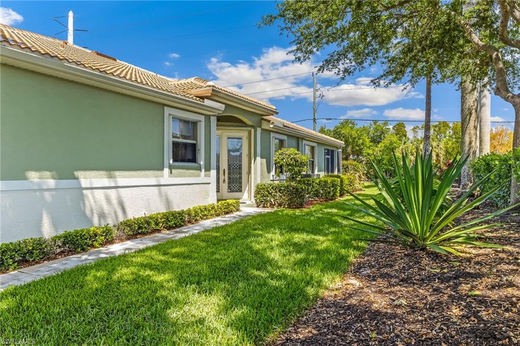 Image 4: Lovely entrance on East side of home, impeccable landscaping and privacy hedge!