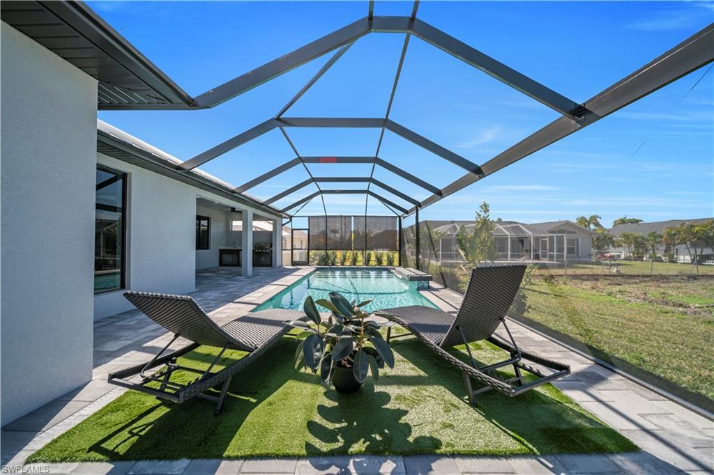 Image 3: Outdoor pool with a patio area, a sunroom, a lanai, and a lawn