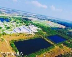 Image 2: Aerial view of property and surrounding area featuring a nearby body of water