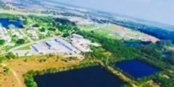 Image 2: Aerial view of property and surrounding area featuring a nearby body of water