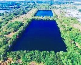 Image 3: Aerial view of property and surrounding area featuring a large body of water