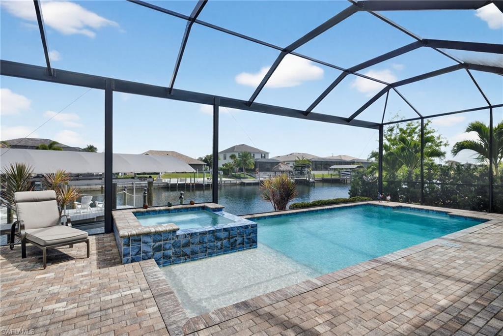 Image 4: Integrated pool / spa with a lanai and a water view