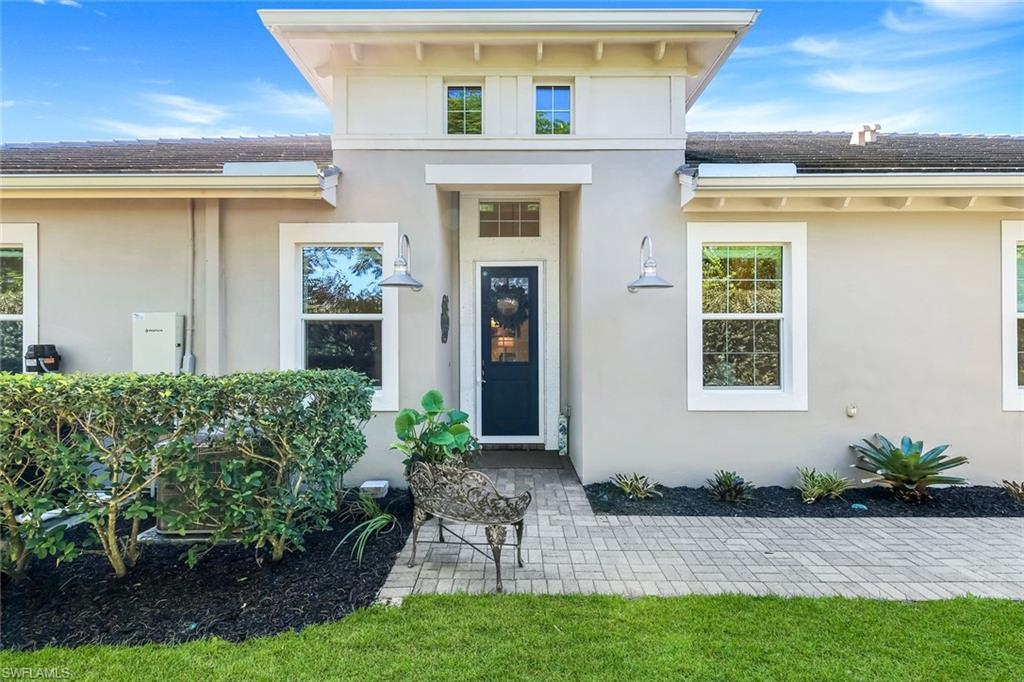 Image 4: Entrance to property featuring stucco siding