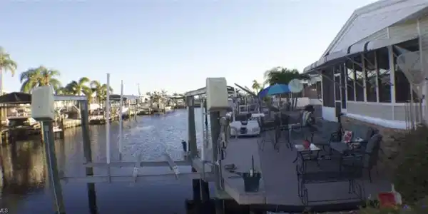 Image 3: Dock featuring a water view and boat lift