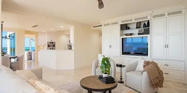 Image 3: Living area with ceiling fan, a chandelier, and light marble finish floors
