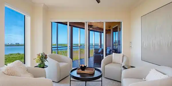 Image 4: Living area featuring a water view, ornamental molding, a sunroom, and ceiling fan