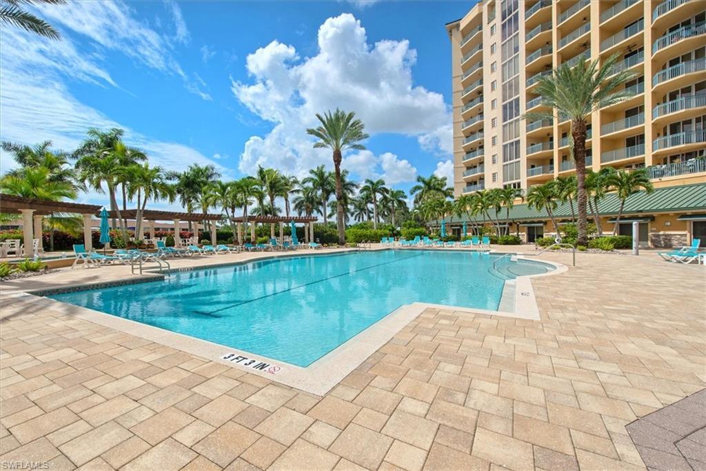 Image 2: Community pool featuring a patio