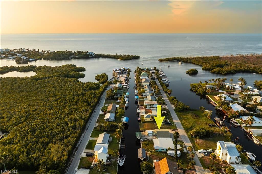 Image 1: Aerial view of property and surrounding area with a nearby body of water