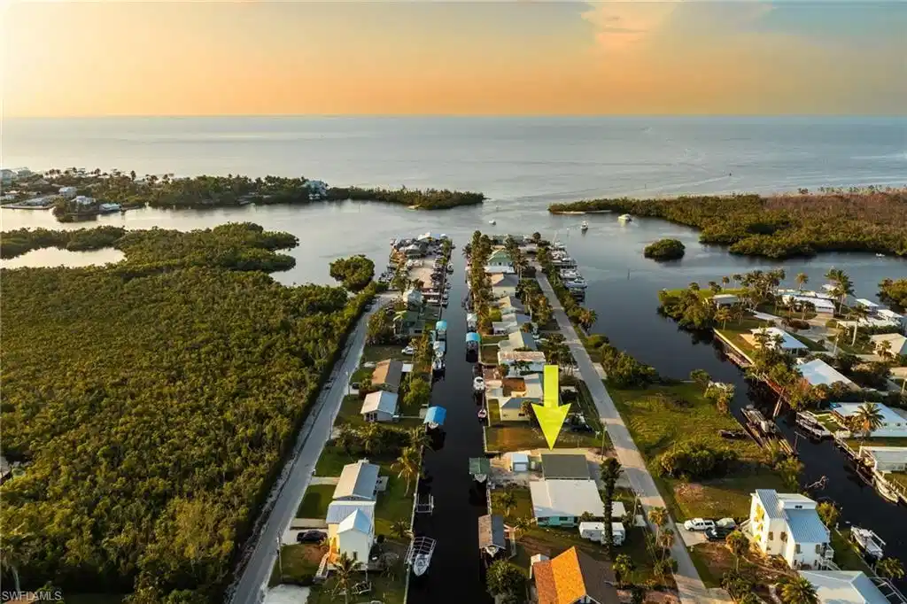 Image 1: Aerial view of property and surrounding area with a nearby body of water