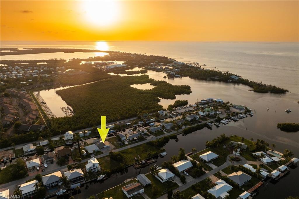 Image 2: Aerial view at dusk of a water view and a residential view