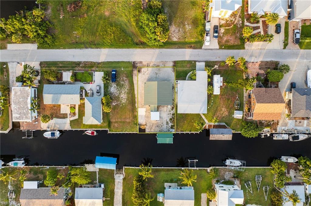 Image 3: Aerial perspective of suburban area featuring a nearby body of water