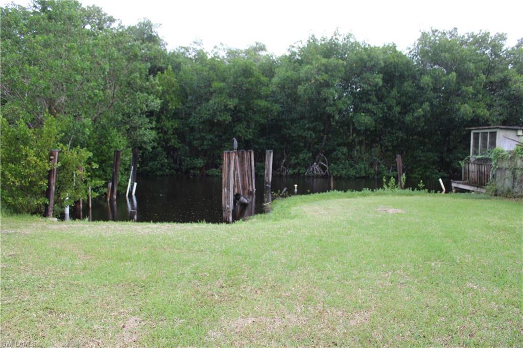 Image 4: View of green lawn featuring a boat slip.