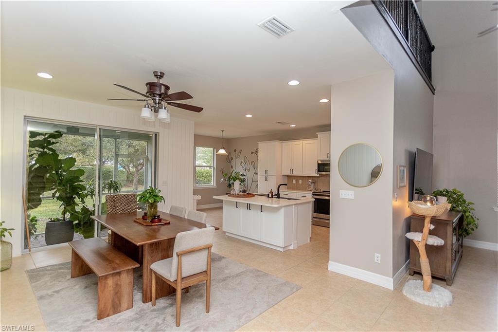 Image 4: Dining room with a ceiling fan and recessed lighting