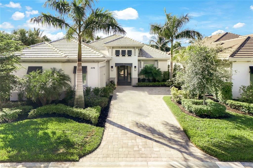 Image 2: Contemporary single-story residence featuring a tile roof and a paver driveway