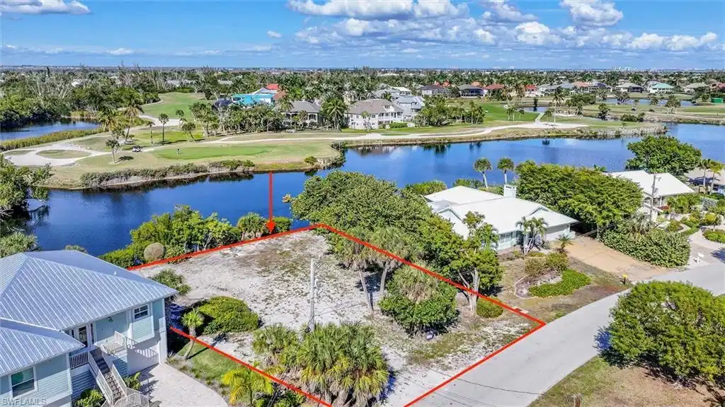 Image 1: Aerial perspective of suburban area featuring a nearby body of water and property boundaries highlighted