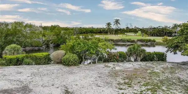 Image 3: Water view featuring a tree filled landscape