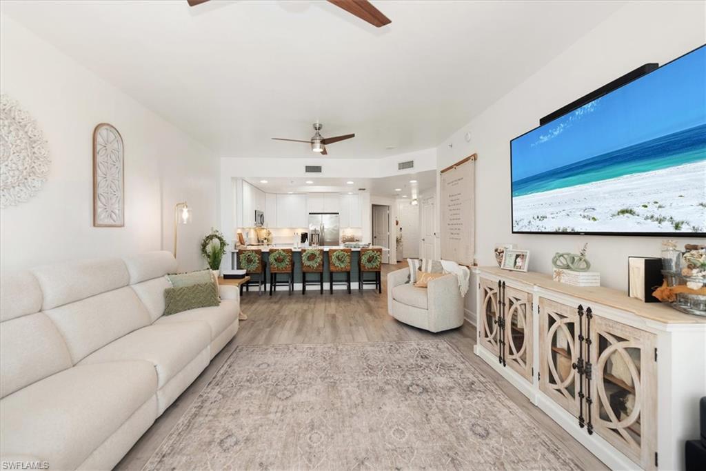 Image 4: Living area featuring light wood-type flooring and ceiling fan