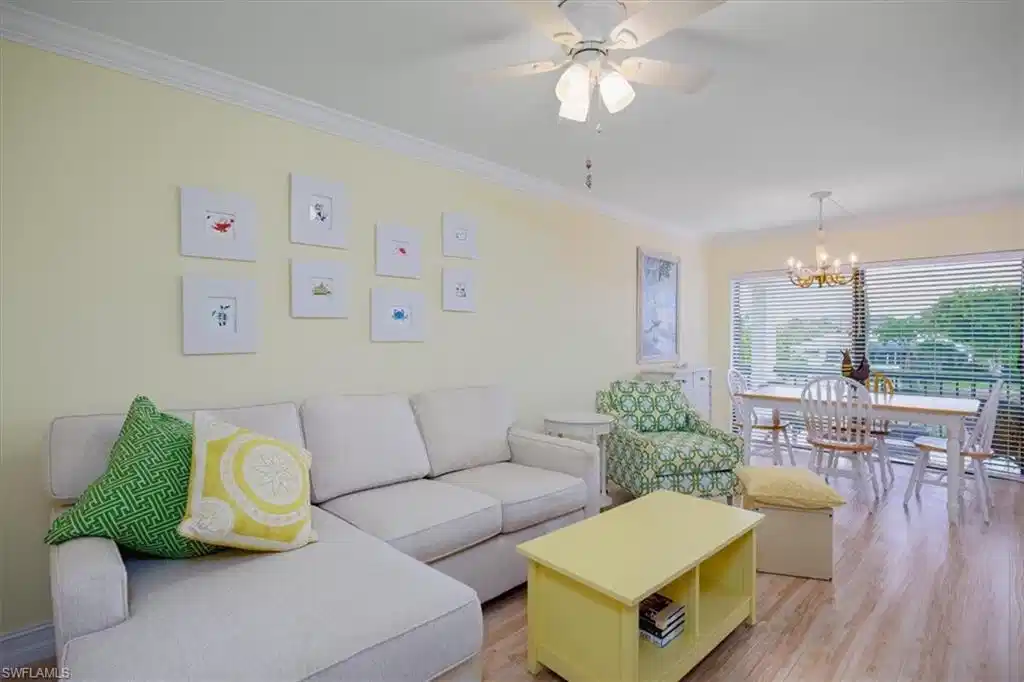 Image 1: Living area featuring ornamental molding, light wood-style floors, a chandelier, and a ceiling fan