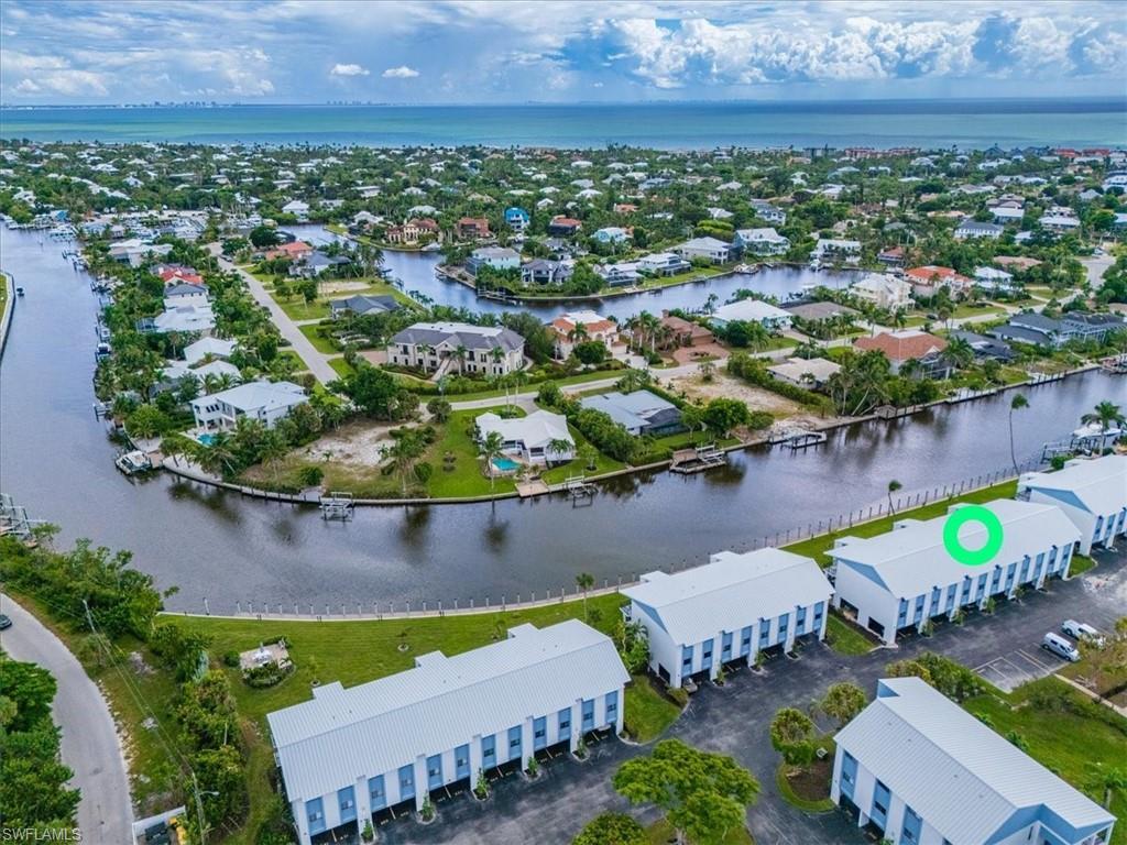 Image 3: Aerial perspective of suburban area with a large body of water