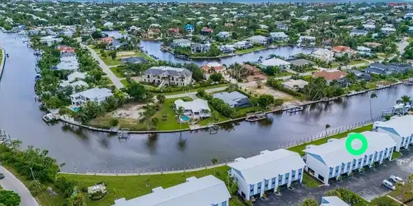 Image 3: Aerial perspective of suburban area with a large body of water