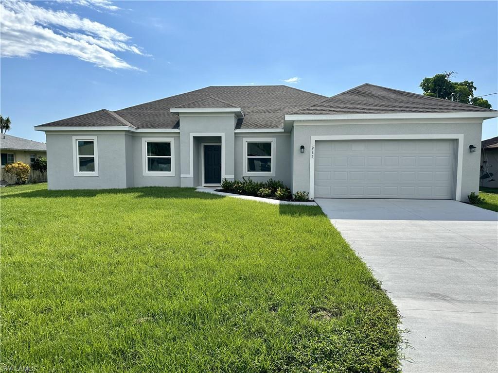 Image 1: View of front of home with roof with shingles, an attached garage, concrete driveway, stucco siding, and a front yard