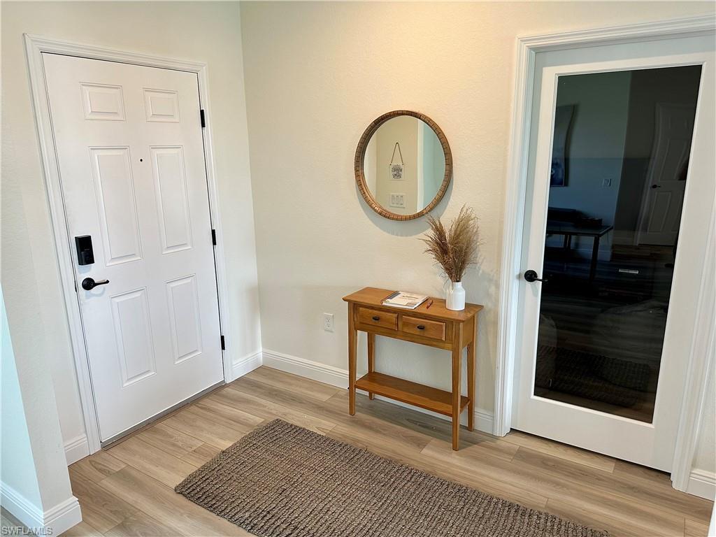 Image 2: Entrance foyer featuring baseboards and light wood-style floors