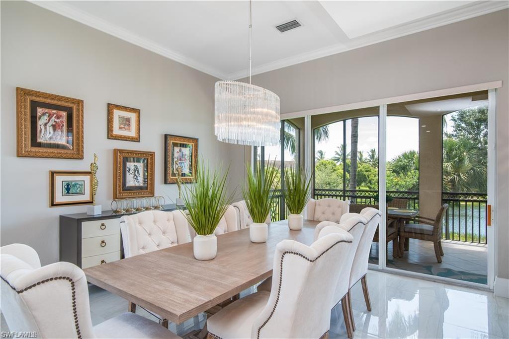Image 4: Dining space with crown molding and a chandelier