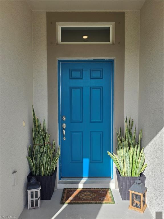 Image 4: Doorway to property with stucco siding