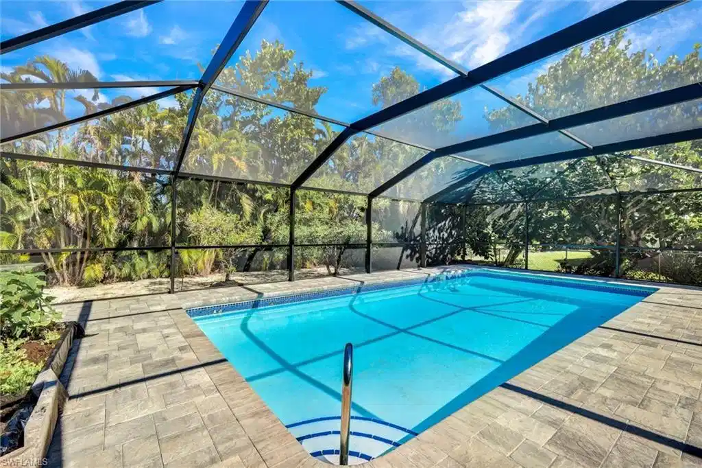 Image 1: Outdoor pool featuring a lanai and a sunroom