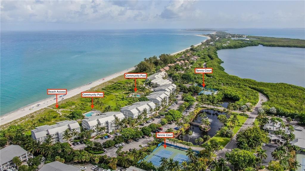 Image 1: Bird's eye view with a water view and a beach view