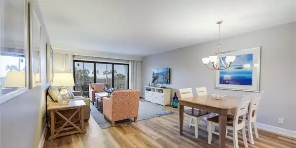 Image 4: Dining room with an inviting chandelier and light hardwood / wood-style floors