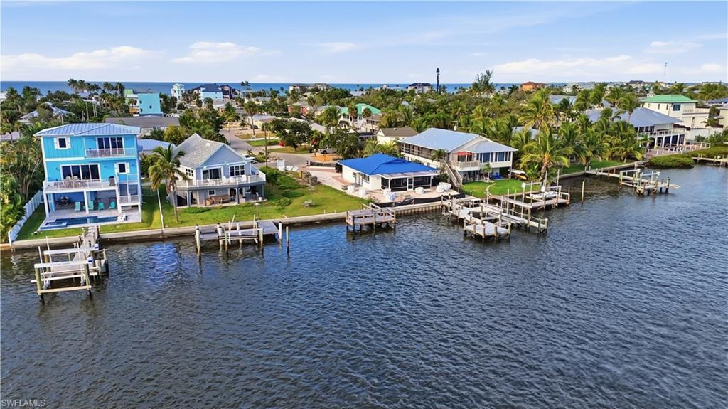 Image 2: Aerial view of residential area with a nearby body of water - Virtually Edited Image