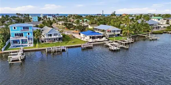 Image 2: Aerial view of residential area with a nearby body of water - Virtually Edited Image