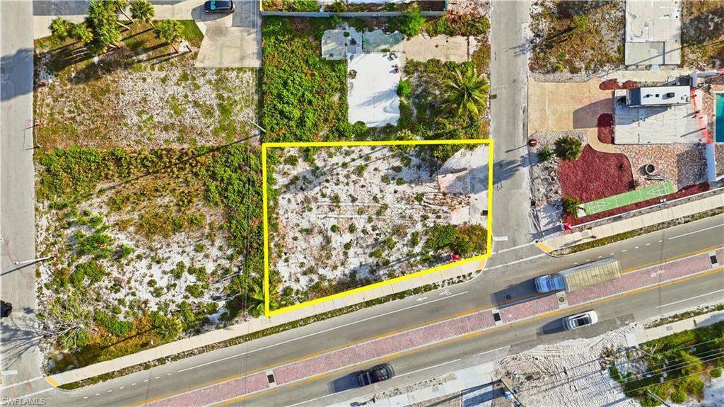 Image 4: Aerial view of property and surrounding area featuring property boundaries highlighted - Virtually Edited Image