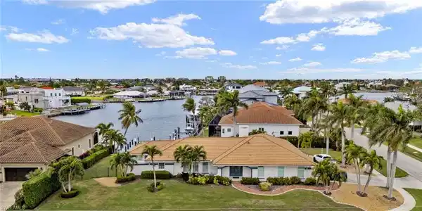 Image 3: Aerial view of residential area with a nearby body of water