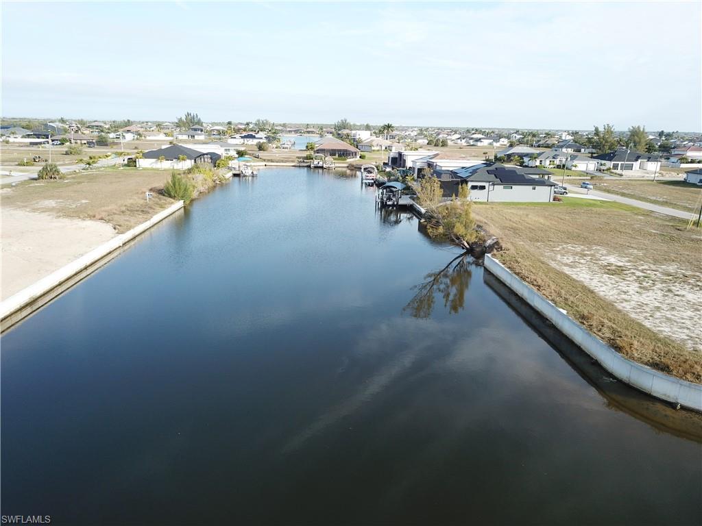 Image 3: Aerial view of residential area featuring a large body of water