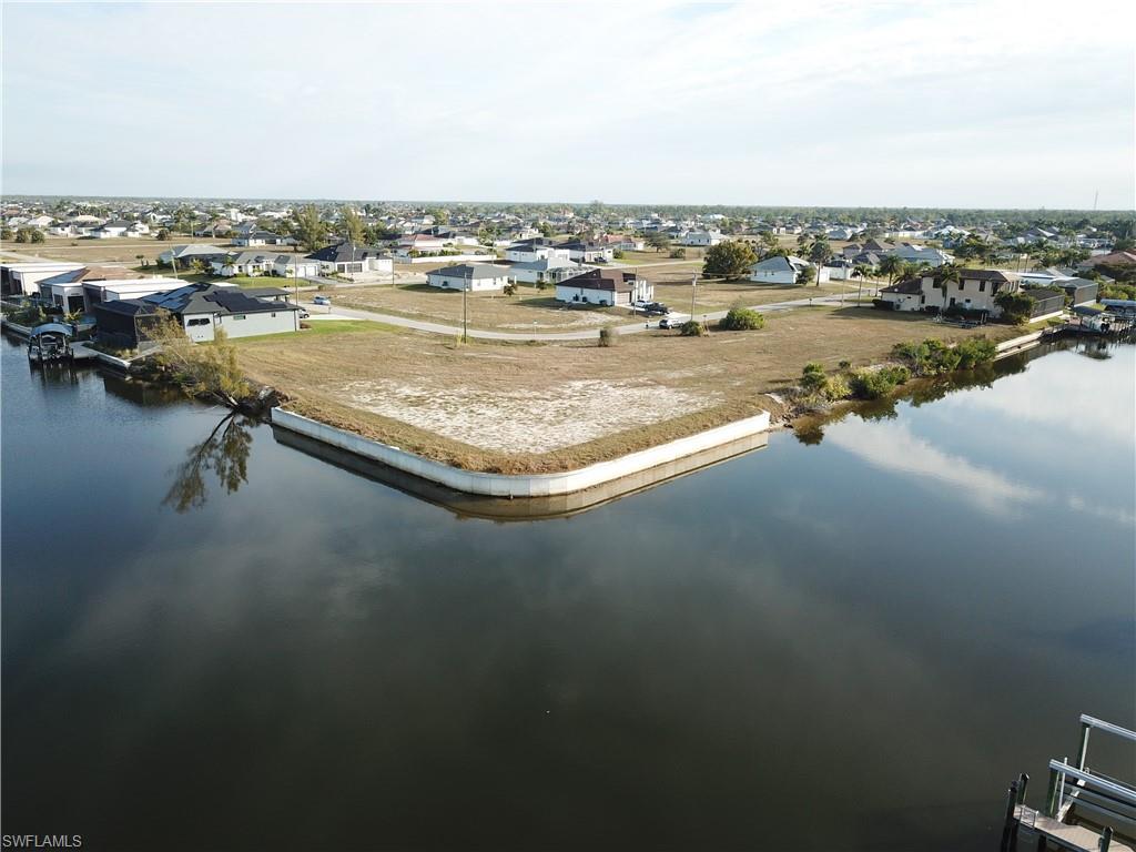 Image 4: Aerial view of residential area with a nearby body of water