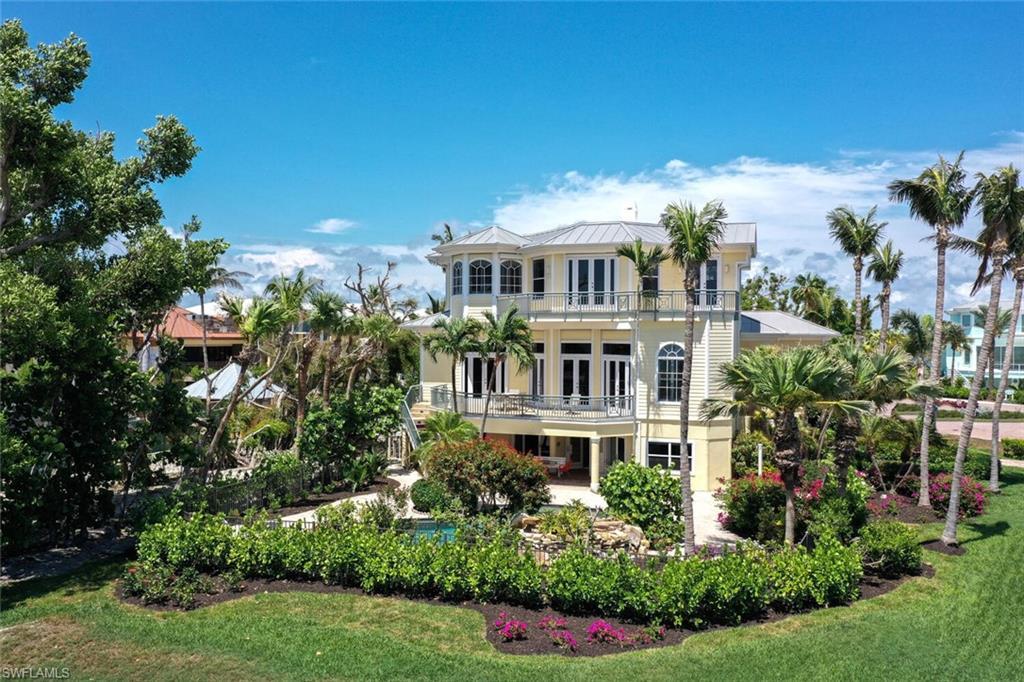 Image 3: Rear view of house featuring french doors, a balcony, and a lawn