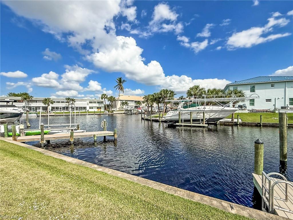 Image 4: Dock area featuring a water view and a yard