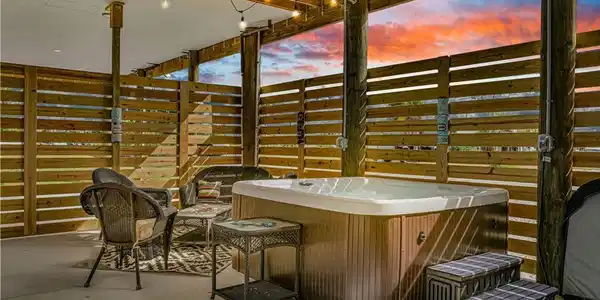 Image 2: View of patio featuring a hot tub