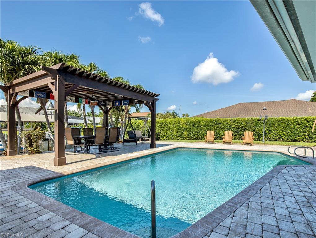 Image 3: View of swimming pool featuring a pergola and a patio area