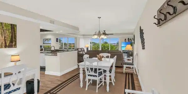 Image 3: Dining space with light wood-type flooring, an inviting chandelier, and sink