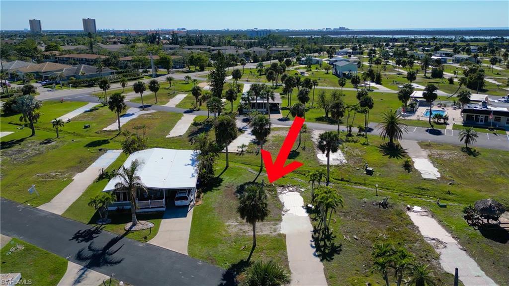 Image 2: Aerial view of property's location with a park and nearby suburban area